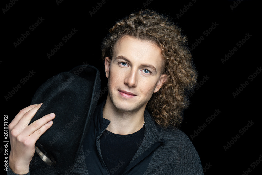 Fototapeta premium man posing holding black hat