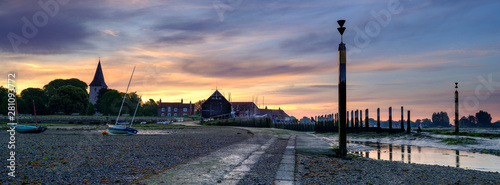 Summer sunrise over the Holy Trinity Church and Bosham Quay in West Sussex, UK