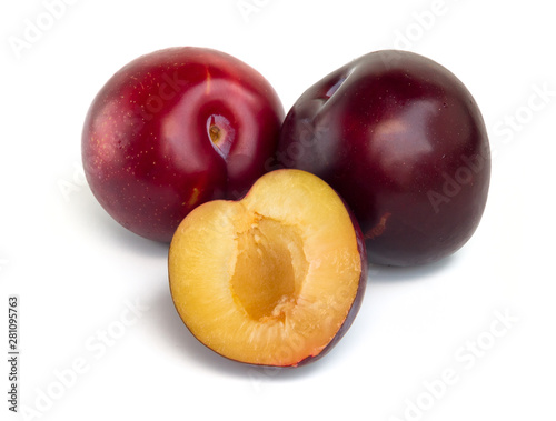 Three red and purple plums isolated on white background