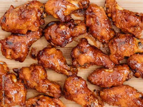 Crispy barbecue chicken wings covered in a sweet and tangy bbq sauce and served at a cookout.
