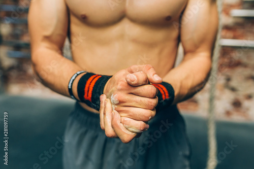 Midsection of man clasping hands with talc
