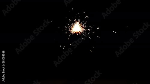 Slowed down video of burning sparkler in dark. Fiery bengal light on black background in 4k ultrahd (UHD) 3840x2160