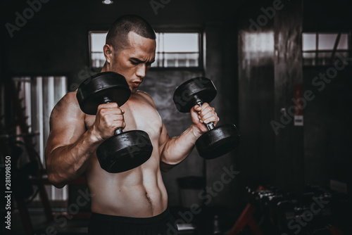 Portrait of asian man big muscle at the gym,Thailand people,Workout for good healthy,Body weight training,Fitness at the gym concept,Prank to abdominal muscles,Lift up dumpbell © reewungjunerr