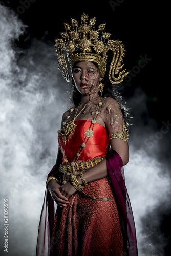 Portrait of asian woman wear ancient thai dress style and makeup ghost face at the old castles at night scene,Thailand people