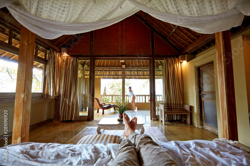 Low section of man lying on bed photo