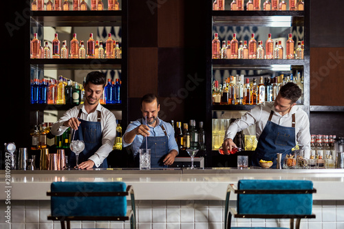 Bartenders working in bar photo
