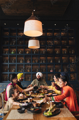 Smiling family enjoying dinner in restaurant photo