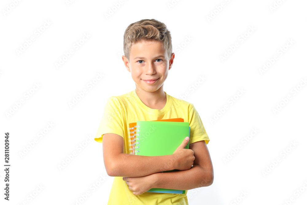 Boy in yellow t-shirt with copybooks isolated on white background Boy in yellow t-shirt with copybooks isolated on white background
