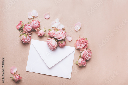 White envelope with pink roses. Congratulation with wedding, birthday, valentines day. © Dariia