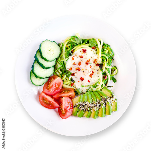 Healthy delicious keto paleo breakfast: egg in a hole in zucchini noodles with avocado, cucumber and tomato. White background. Top view.