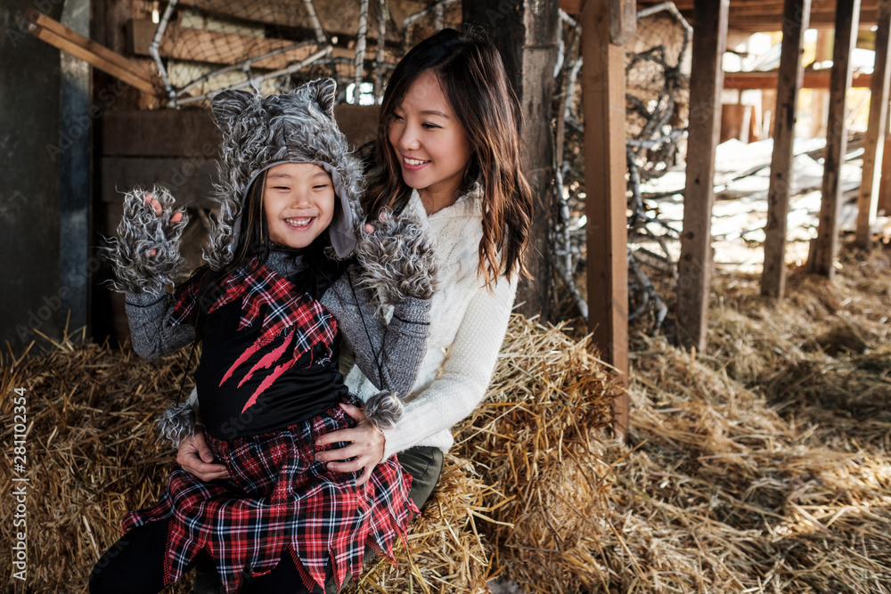 Asian Mother and Daughter Pumpkin Patch During Fall Season Asian Mother and Daughter Pumpkin Patch During Fall Season
