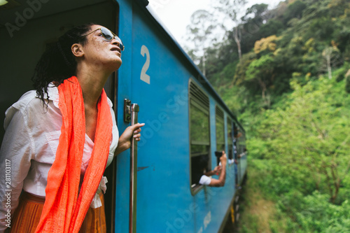 Woman Leaning Out Of A Train In The Countryside photo