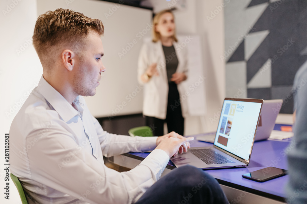 Group of people having a meeting in the modern office, woman using a mobile phone Group of people having a meeting in the modern office, woman using a mobile phone