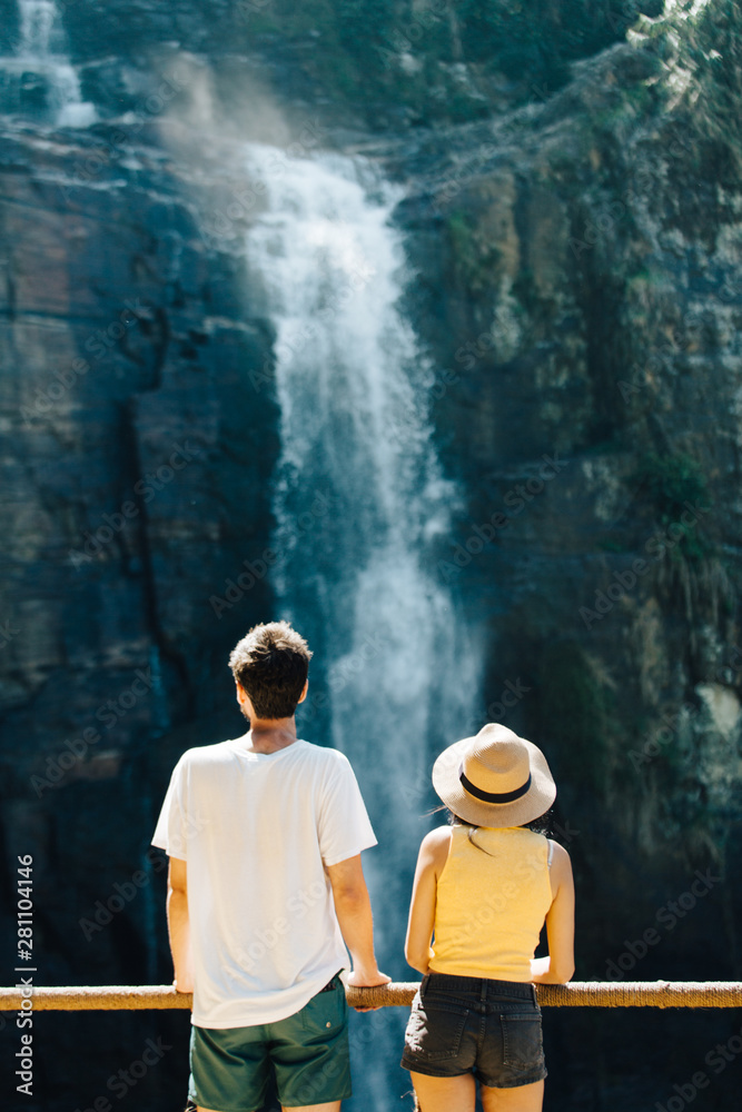 Couple Standing In Front Of A Waterfall