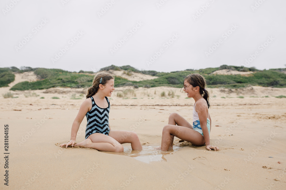 Girls playing in shallow water on beach Girls playing in shallow water on beach