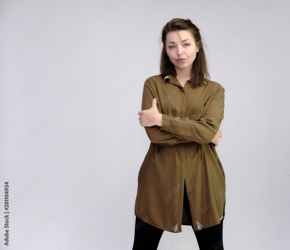 A portrait above the knee of a pretty adult brunette girl in a dress on a white background. Standing directly in front of the camera, showing different poses and emotions. A portrait above the knee of a pretty adult brunette girl in a dress on a white background. Standing directly in front of the camera, showing different poses and emotions.