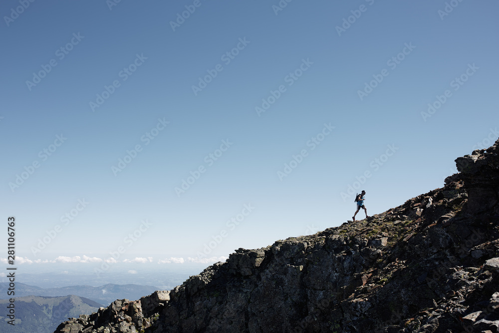 Silhouette of a man running uphill Silhouette of a man running uphill