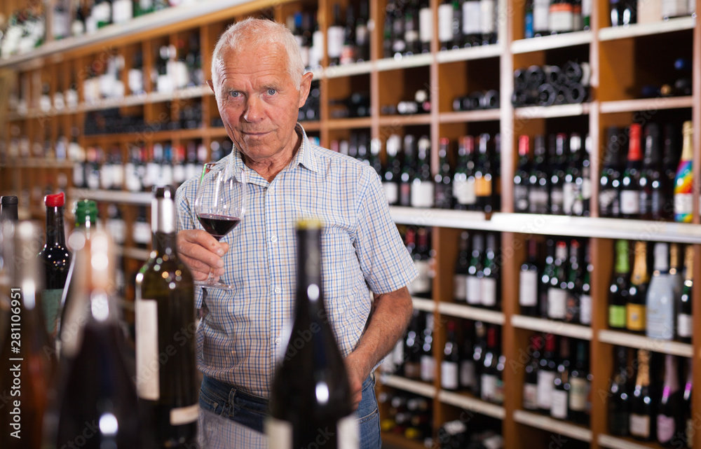 Senior male tasting wines in winery