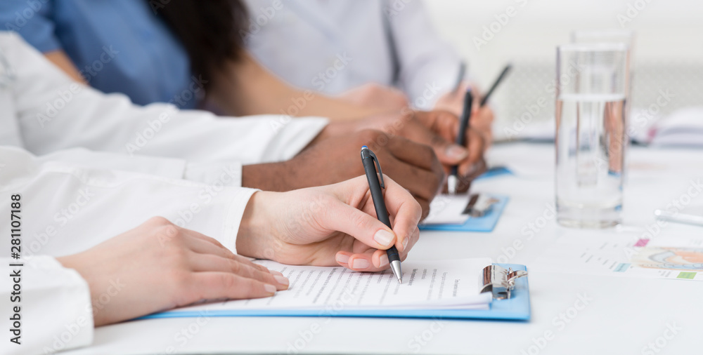 Medical seminar. Doctors writing notes at conference Medical seminar. Doctors writing notes at conference