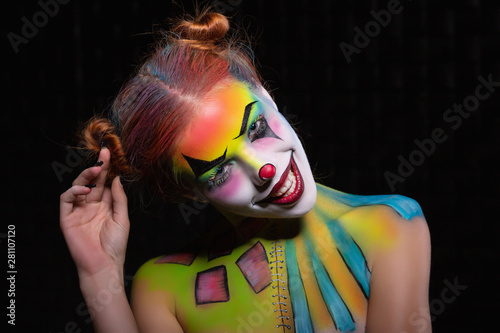 Smile lady with a face painting clown.