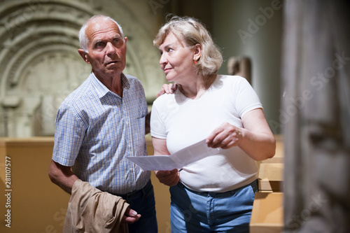 Male and female pensioners visiting museum