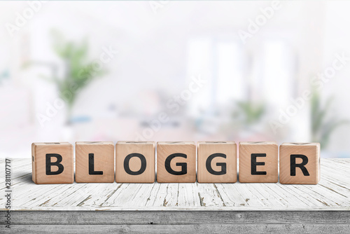 Blogger sign in a bright living room with green plants