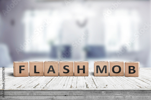 Фотография Flash mob message sign on a table in a bright room