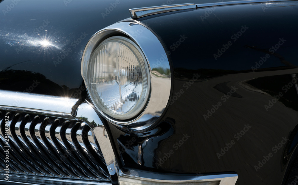 Headlight and grille fragment of a retro car