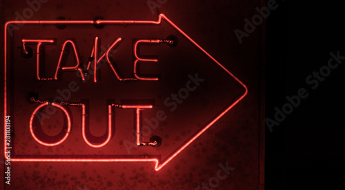 A grimy neon arrow with 'Take Out' written inside.