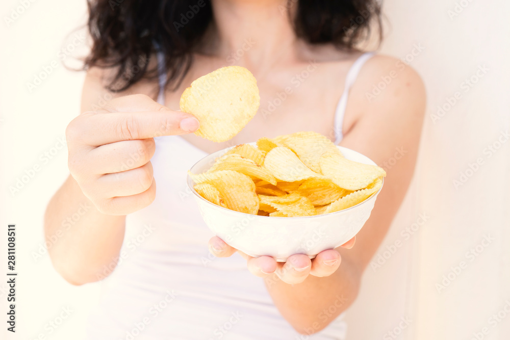 A girl holding the big potato chips bowl. Asking to eating together, Happiness sharing concept. White background. A girl holding the big potato chips bowl. Asking to eating together, Happiness sharing concept. White background.