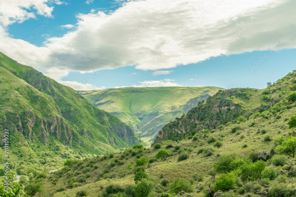 Panoramic view of Vardzia cave monastery town. View from the monastery to the river valley and green slopes on a sunny summer day