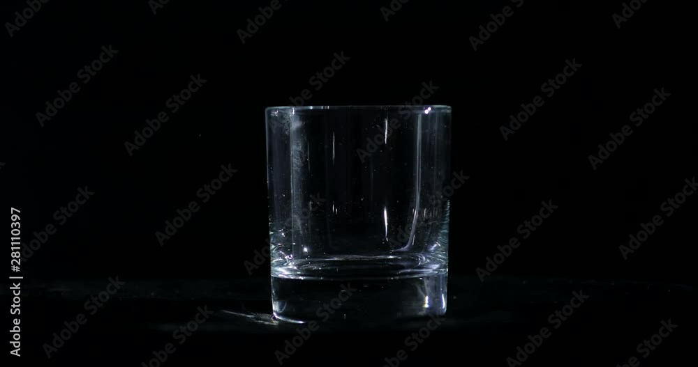 Wiping, cleaning, polishing the whiskey, alcohol glass, preparing, making it ready for filming