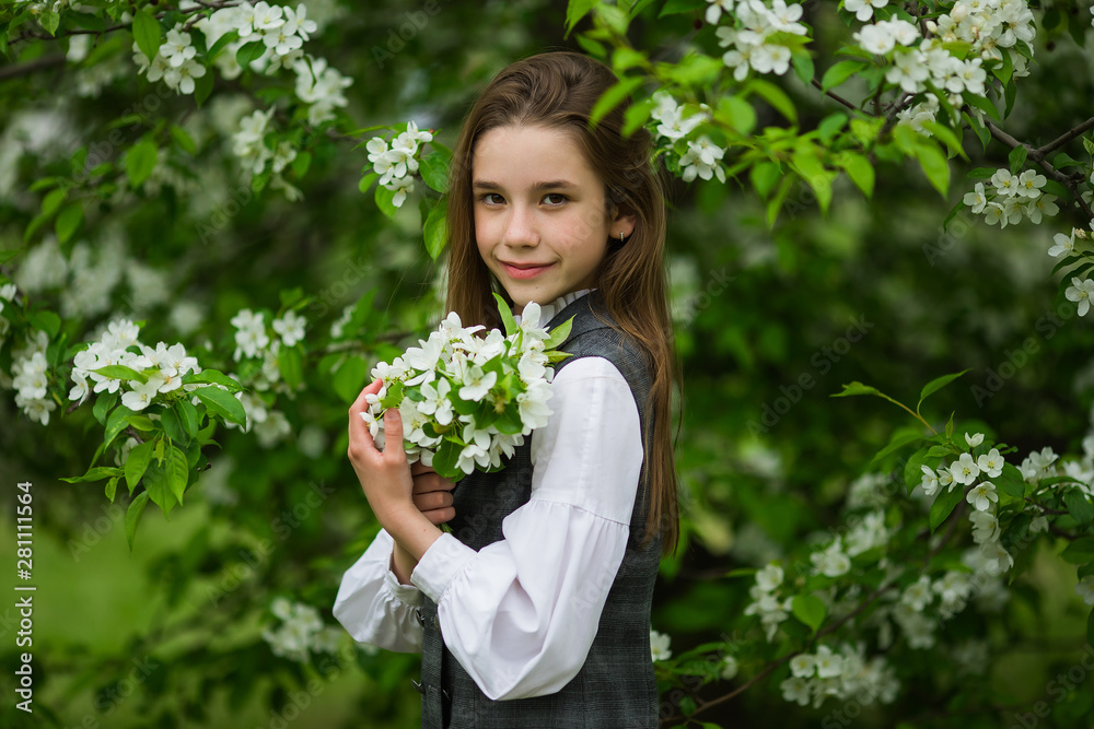 Sweet pretty pupil after school in school uniform in the park. The concept of school, study, education, friendship, childhood. Sweet pretty pupil after school in school uniform in the park. The concept of school, study, education, friendship, childhood.