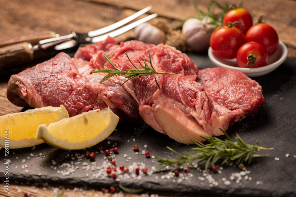 Raw fresh meat on a black cutting board