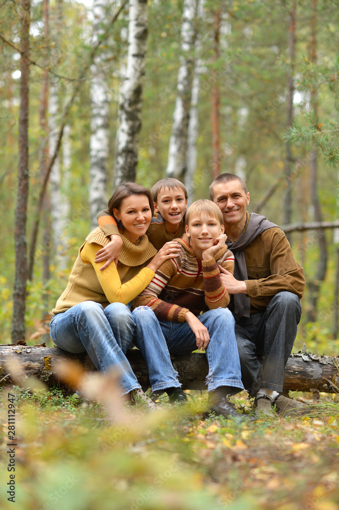 Portrait of family of four in park