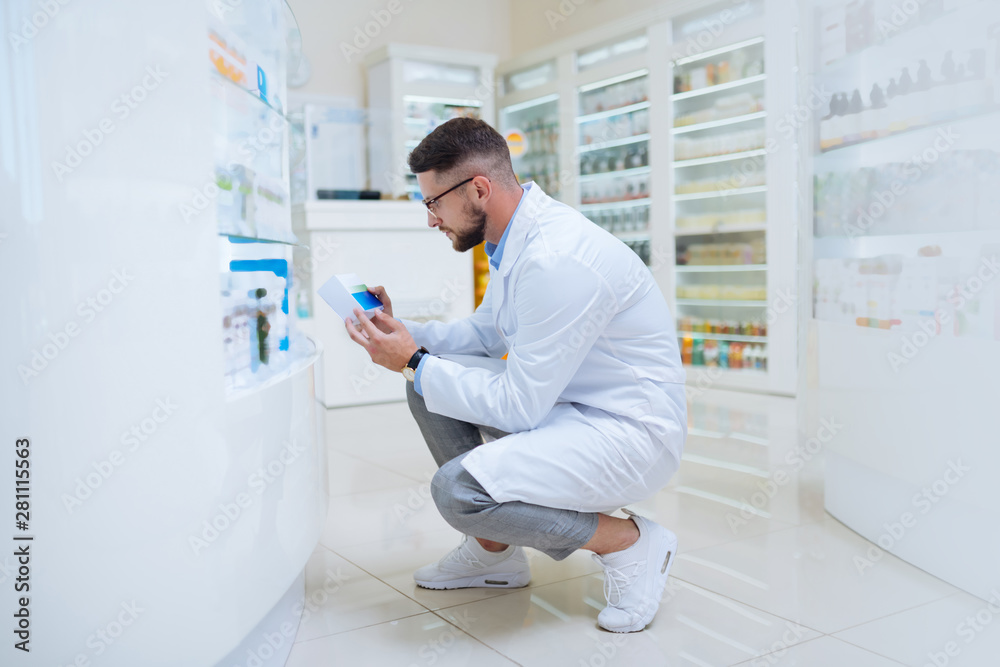 Cheerful bearded man working in drug store Cheerful bearded man working in drug store
