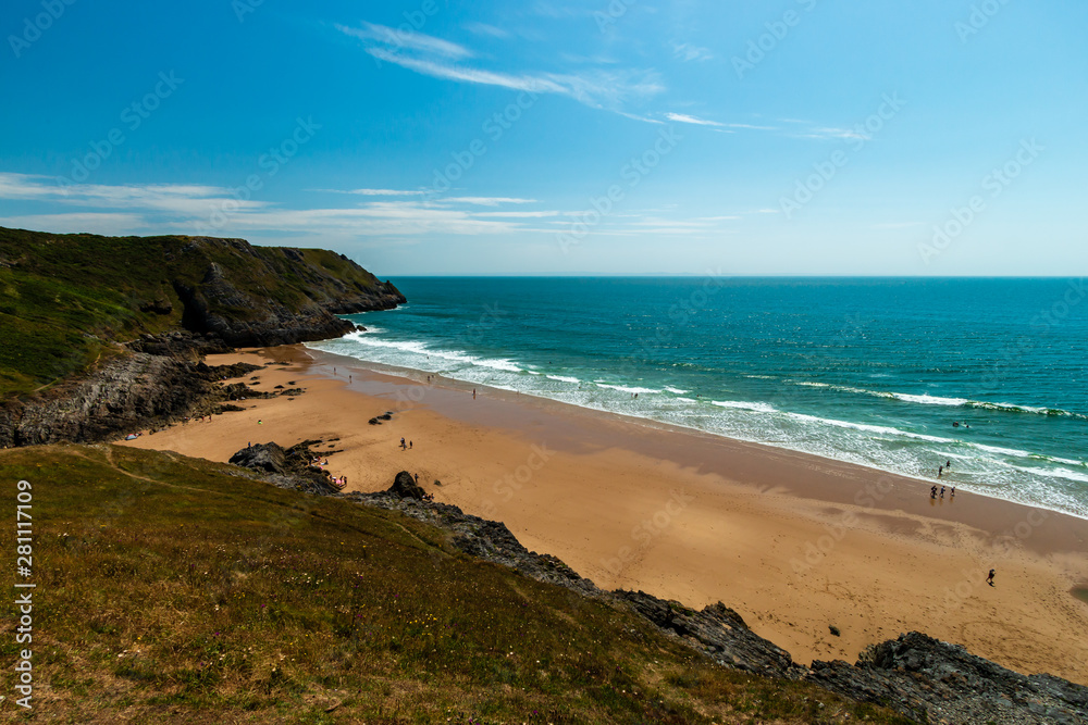 A sandy beach surrounded by cliffs (Pobbles, Gower, Wales) A sandy beach surrounded by cliffs (Pobbles, Gower, Wales)