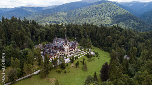 Aerial view of a castle in a forest on a sunny day 