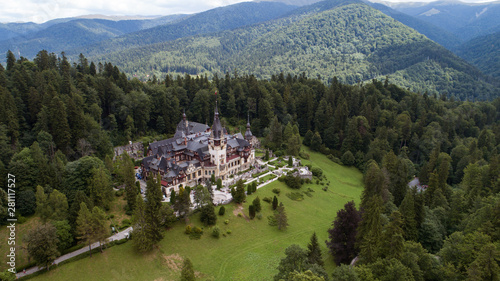 Aerial view of a castle in a forest on a sunny day 