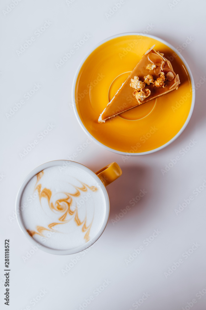 Cup of hot cappuccino coffee with cake