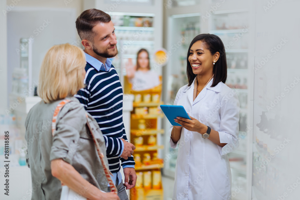 Positive delighted international chemist welcoming her client