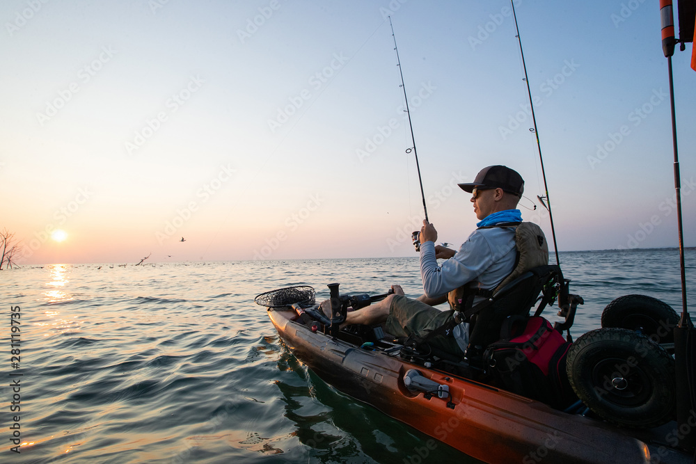 Young Man Kayak Fishing at Sunrise in Canada