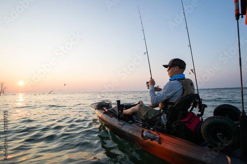 Obraz na płótnie Young Man Kayak Fishing at Sunrise in Canada w salonie