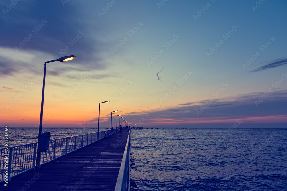 Vintage look of a pontoon bridge with light poles over Black Sea in the early morning hours before sunrise
