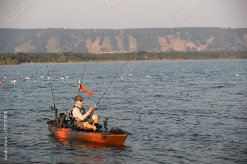 Young Man Kayak Fishing at Sunrise in Canada