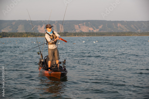 Young Man Kayak Fishing at Sunrise in Canada