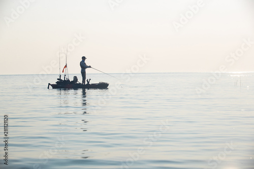 Obraz na płótnie Young Man Kayak Fishing at Sunrise in Canada w salonie