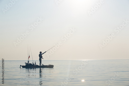 Obraz na płótnie Young Man Kayak Fishing at Sunrise in Canada w salonie