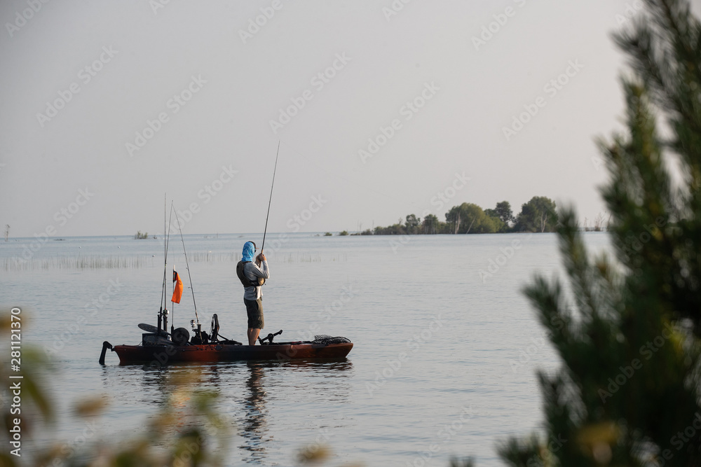 Young Man Kayak Fishing at Sunrise in Canada