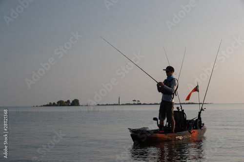 Young Man Kayak Fishing at Sunrise in Canada